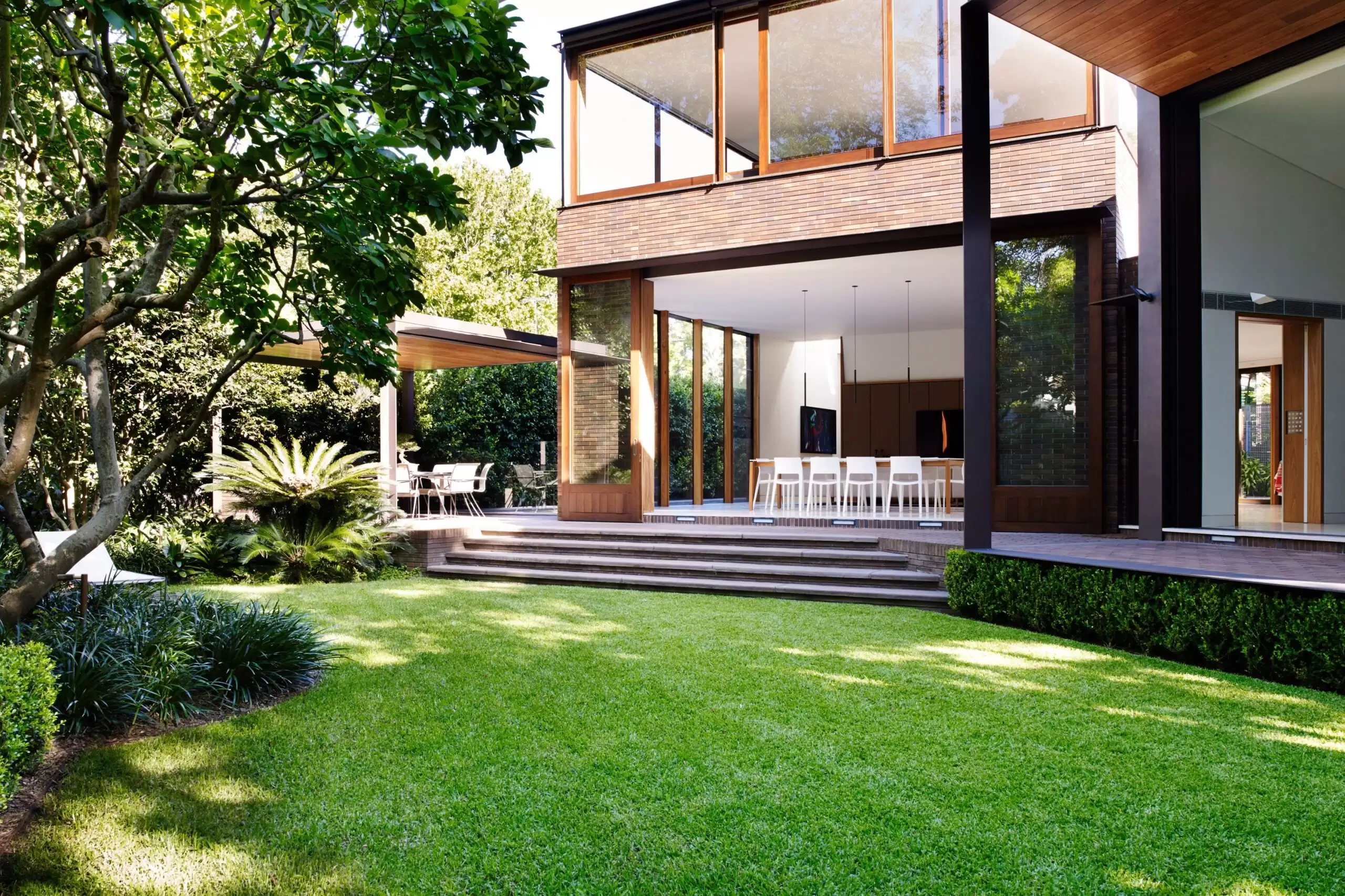Photograph of dining space from the garden in the Garden House designed by Tzannes