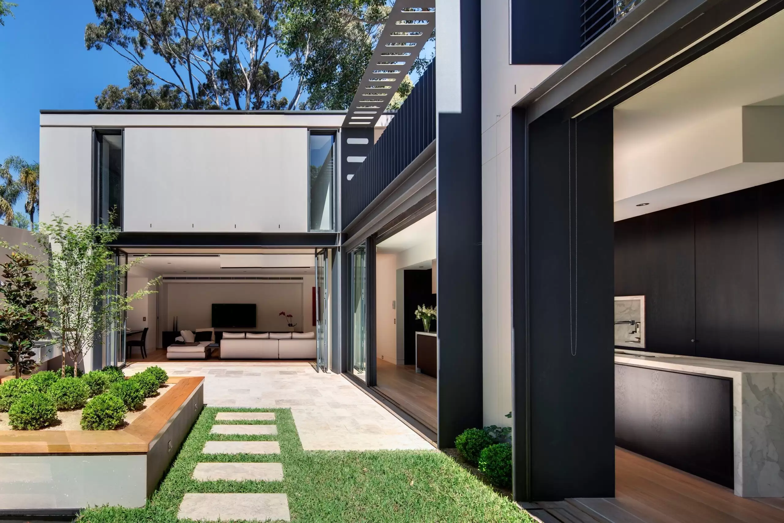 Photograph of formal living space with new steel and timber staircase in the Paddington Corner House designed by Tzannes