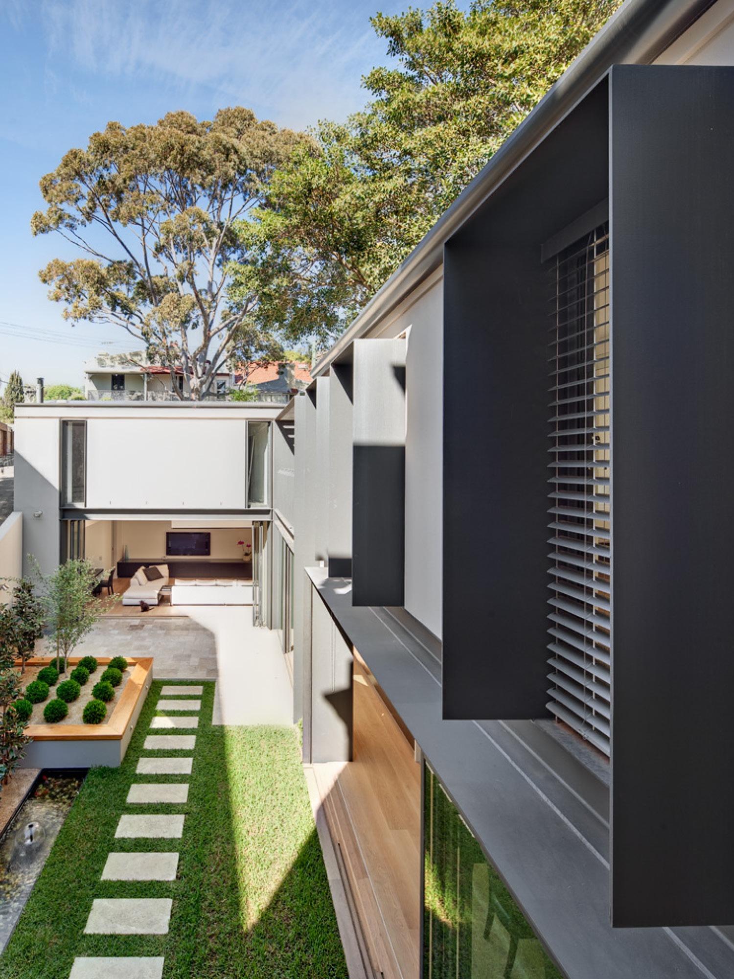 Photograph of courtyard and ground floor living space from balcony of the Paddington Corner House designed by Tzannes