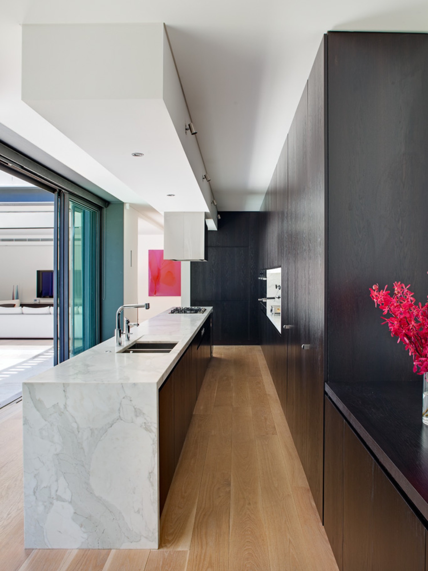Photograph of ground floor kitchen and informal living beyond in the Paddington Corner House designed by Tzannes