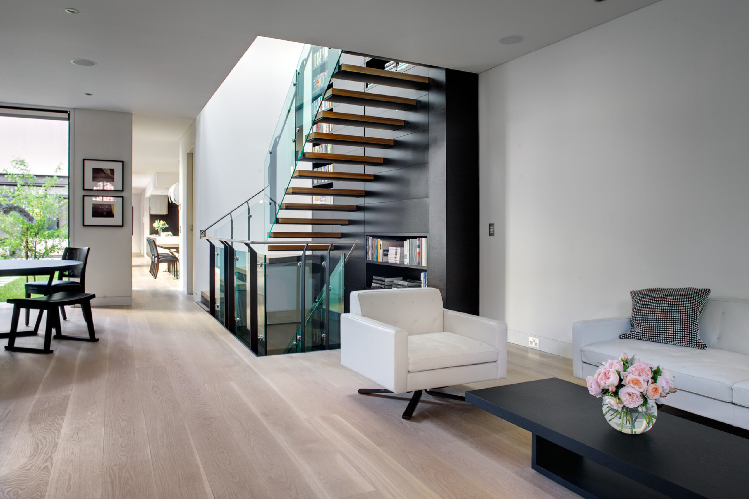 Photograph of formal living space with new steel and timber staircase in the Paddington Corner House designed by Tzannes