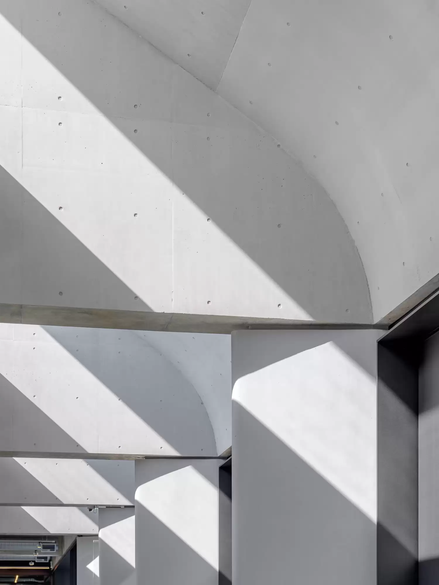 Photograph showing sculptural connection between curved concrete soffit, beams and columns in the award-wining Dangrove Art Storage Facility designed by Tzannes